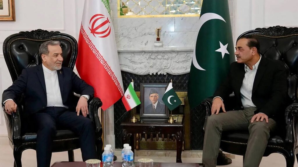 High-level diplomatic representatives seated in formal discussion during the US-Iran Talks in Islamabad, positioned between the Iranian and Pakistani national flags to discuss vital steps for regional success.