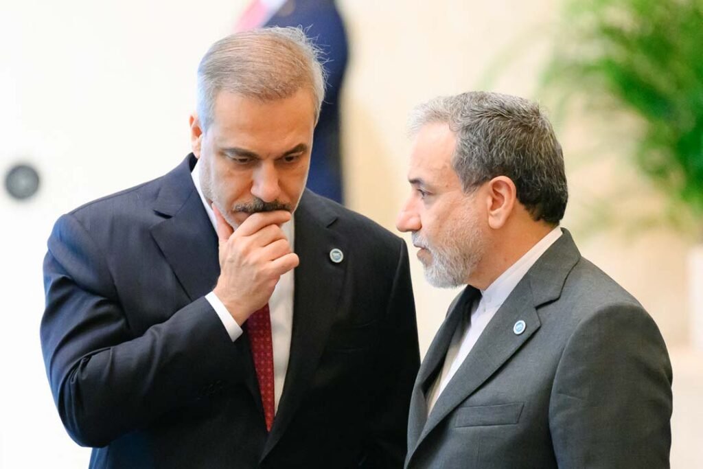 Türkiye Charts a Distinctive Course amid Middle East Turmoil Turkish Foreign Minister Hakan Fidan is shown in deep thought alongside Iranian Foreign Minister Abbas Araghchi during an international summit, illustrating diplomatic negotiations amid Middle East Turmoil.