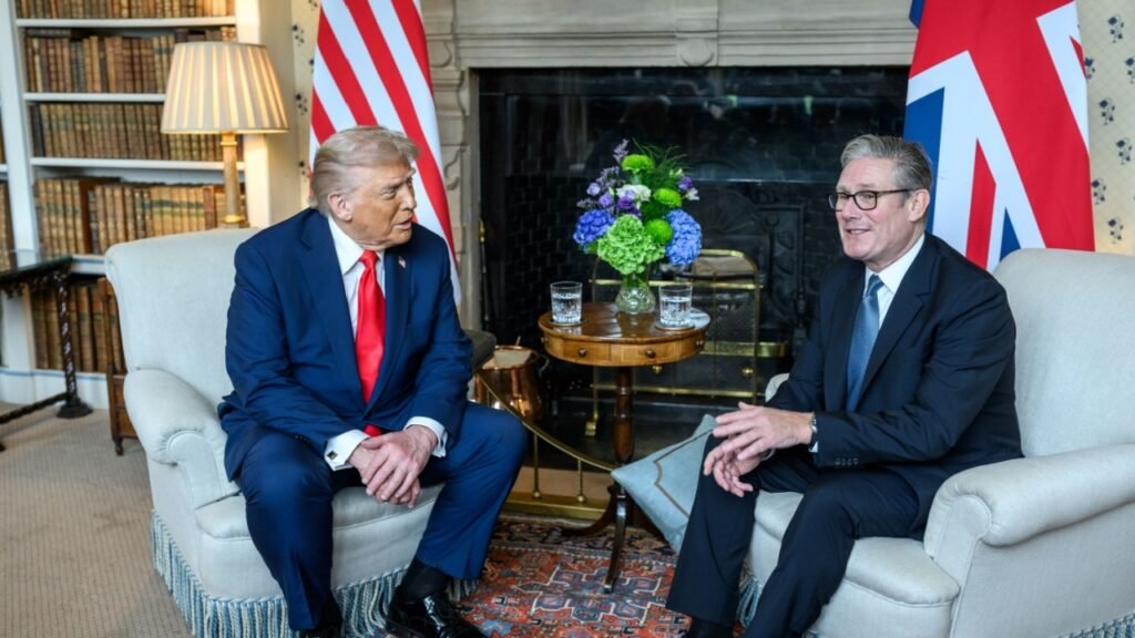 Donald Trump and Keir Starmer seated in a formal meeting room with American and British flags, illustrating the diplomatic complexities and underlying tensions that define the modern Special Relationship and the ongoing US-UK rift.