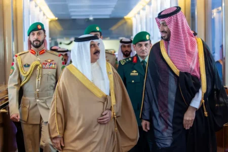 Bahraini King Sheikh Hamad bin Isa al-Khalifa and Saudi Crown Prince Mohammed bin Salman walk together during a formal summit in Jeddah, surrounded by military escorts to demonstrate diplomatic alignment and a new order for the gulf.