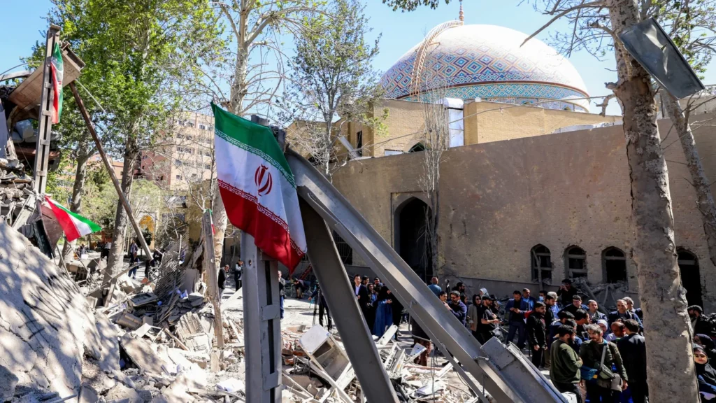 A dramatic view of the University of Tehran main entrance gate, with its iconic crossed-arch concrete structure, serving as a symbol of the academic institutions facing the Attack on Iranian Universities and the resulting political upheaval.