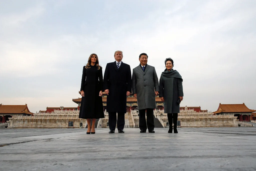 Donald Trump, Melania Trump, Xi Jinping, and Peng Liyuan standing together at the Forbidden City in Beijing, symbolizing the high-stakes diplomacy of the Trump-Xi summit and the concept of strategic patience in US-China relations.