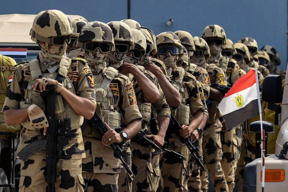 Egyptian forces in the UAE: Gains and losses Rows of military personnel in desert camouflage uniforms stand at attention during a joint training exercise, highlighting the tactical interoperability and strategic deployment of Egyptian forces in the UAE.