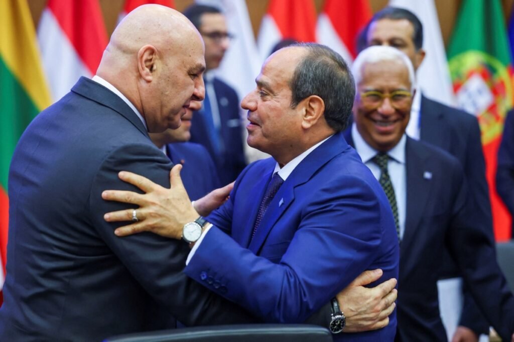 Egyptian President Abdel Fattah el-Sisi embracing a diplomatic counterpart during a summit, representing the regional mediation efforts and high-level engagement necessary for the Lebanon-Israel talks and their strategic warnings.