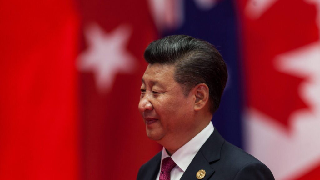 Can China Broker Peace Between the US and Iran? Chinese President Xi Jinping captured in profile against a blurred background of international flags, highlighting Beijing's diplomatic presence and the geopolitical calculations behind China's Mediation in global security issues.