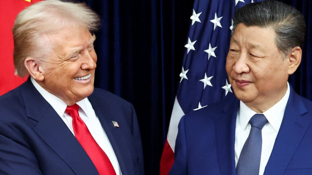 A close-up of Donald Trump and Xi Jinping smiling and looking at each other during a high-stakes meeting with US and Chinese flags in the background, illustrating the complex personal diplomacy and underlying tension of US China Policy Shifts during the 2026 summit.