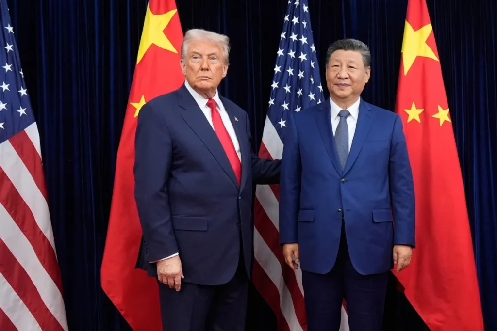 Donald Trump and Xi Jinping standing side-by-side in front of alternating American and Chinese flags, capturing a pivotal moment from the Trump-Xi Summit that signals significant shifts in global power and international diplomacy.