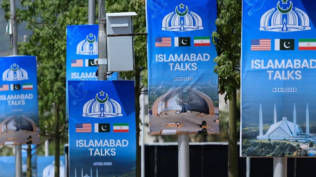 Islamabad Talks banners featuring US, Pakistan, and Iran flags, representing diplomatic efforts to resolve the Iran action impasse and regional war predicaments.