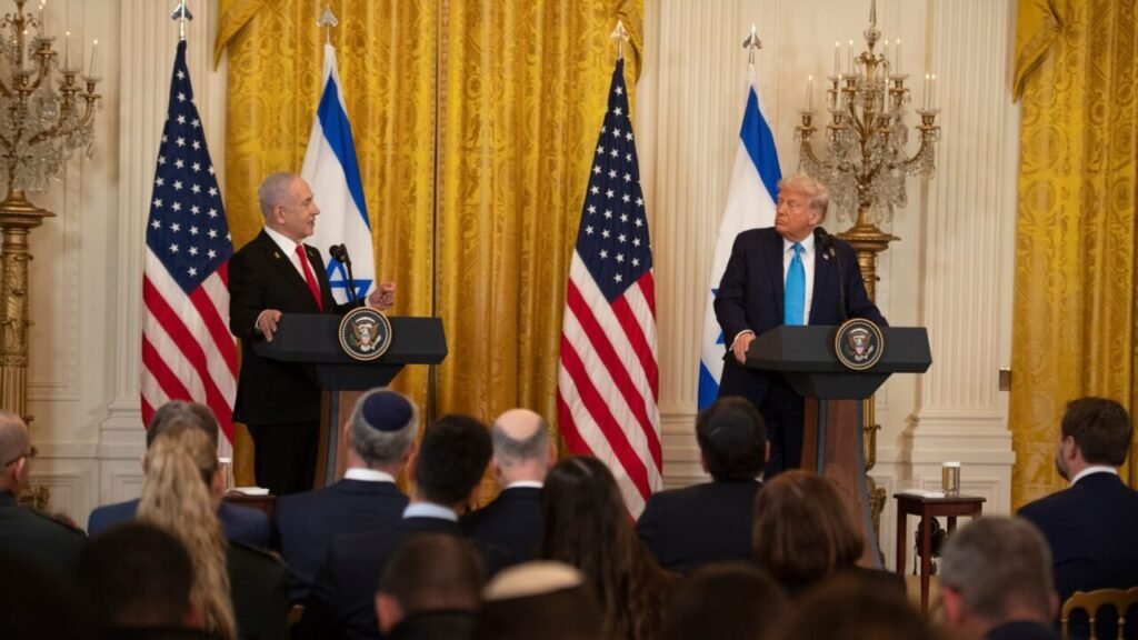 Israeli Prime Minister Benjamin Netanyahu and U.S. President Donald Trump standing behind official presidential lecterns during a joint press conference in the East Room of the White House, surrounded by American and Israeli flags, reflecting the diplomatic discussions regarding Palestinian statehood.