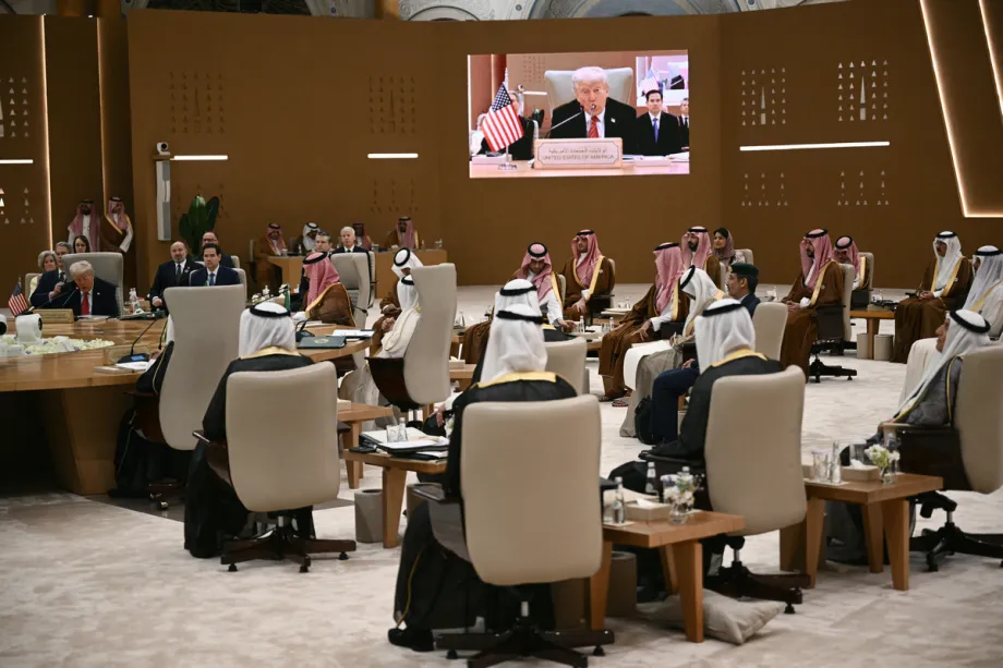 The Iran war is exposing the limits of Gulf defence dependence Gulf leaders in traditional attire sit at a large conference summit watching Donald Trump speak on a projection screen, illustrating the regional vulnerabilities surrounding the future of Gulf defence dependence.