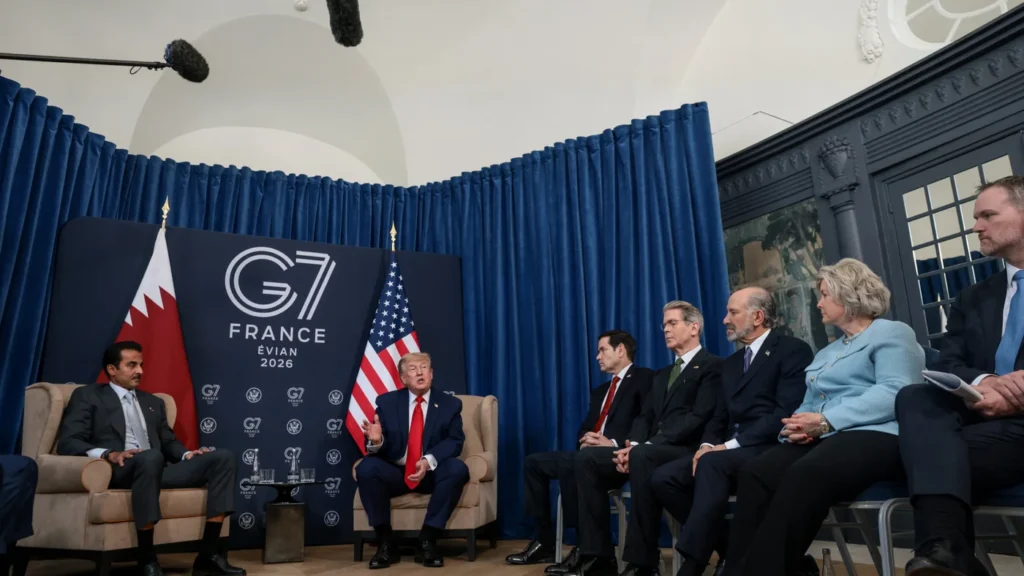 Donald Trump speaks with the Amir of Qatar Tamim bin Hamad Al Thani alongside officials during a bilateral meeting at the G7 summit in Évian, France, providing political context to diplomatic discussions aimed at preventing a broader war on Iran.