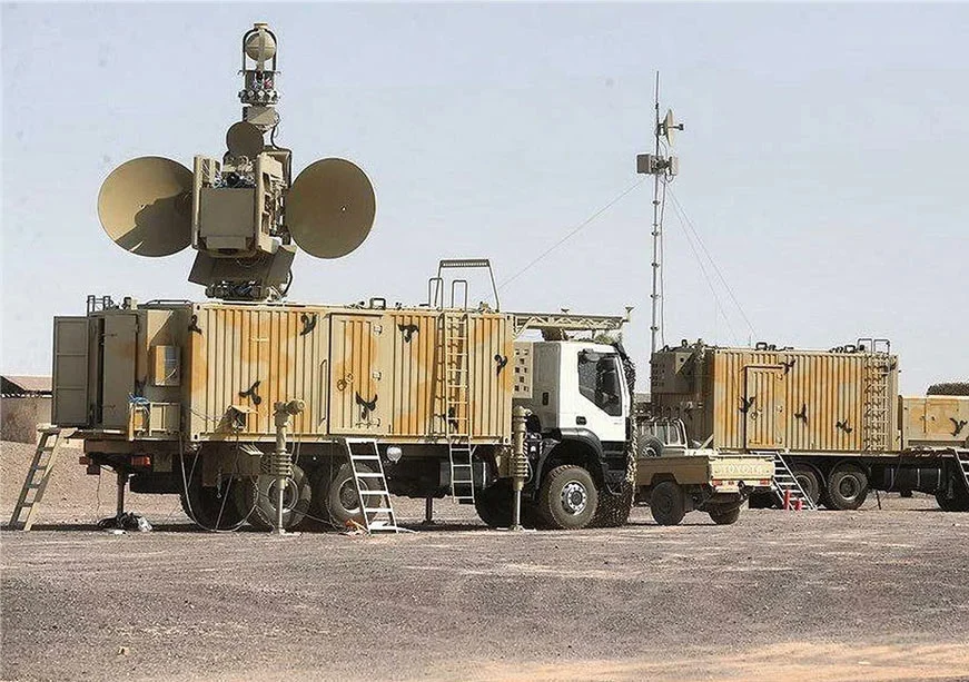 The Role of Navigation Systems in Iran’s Military Success An Iranian military mobile radar and electronic warfare unit mounted on a camo-painted transport truck in a desert deployment, showcasing tactical guidance systems and mobile communication navigation systems.