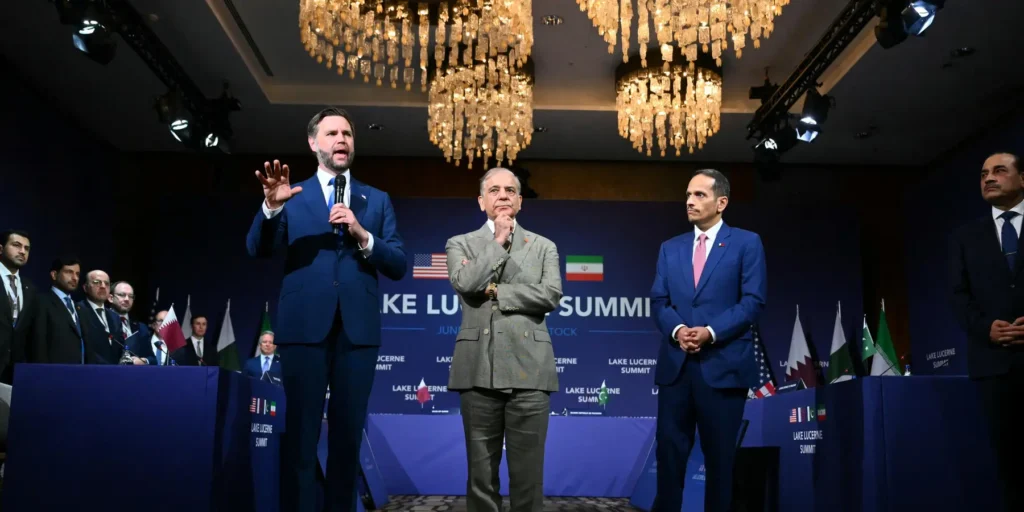 US Vice President JD Vance speaking at a microphone on stage alongside international officials at the Lake Lucerne Summit, addressing geopolitical strategies relevant to the establishment of a deconfliction cell.
