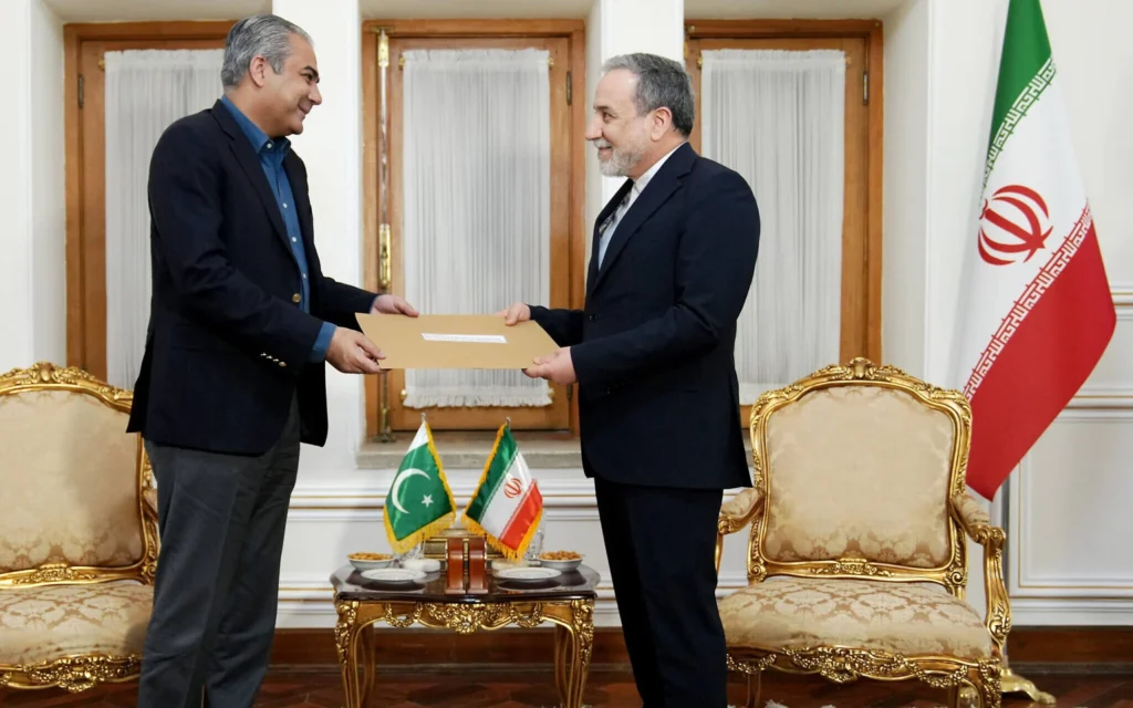 Pakistani Interior Minister Mohsin Naqvi hands a written diplomatic document to Iranian Foreign Minister Abbas Araqchi in Tehran, capturing the regional security alignments influencing the geopolitics of a Postwar Middle East.