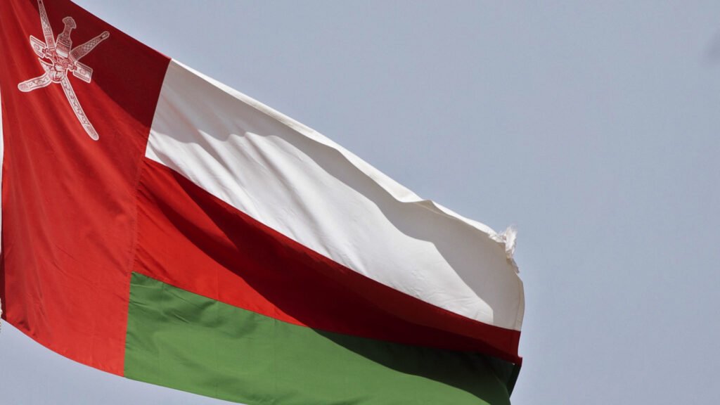 Between Trump and Tehran: Why Oman’s neutrality is under strain Oman's national flag waving in the wind, representing Oman's neutrality in diplomacy between the United States and Iran.
