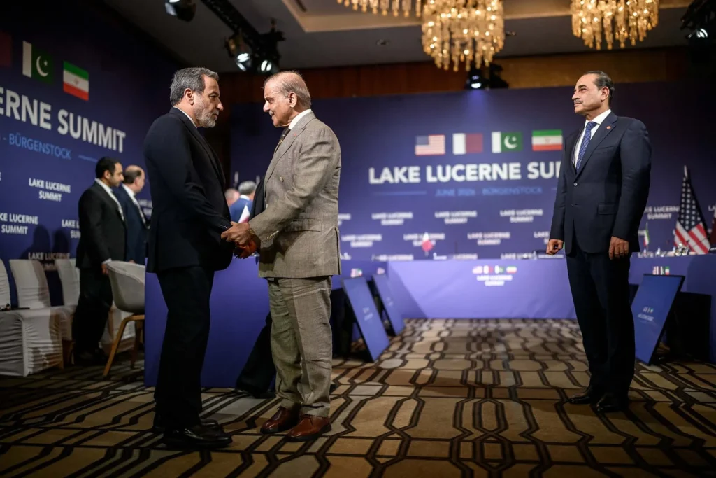 Iran’s Foreign Minister Abbas Araqchi shaking hands with Pakistan’s Prime Minister Shehbaz Sharif at the Lake Lucerne Summit, representing the diplomatic maneuvers behind the Iran's Deal.