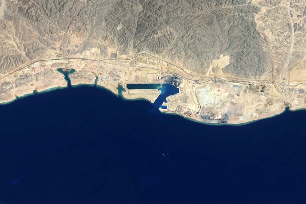 Satellite view of NEOM’s Oxagon industrial city development on Saudi Arabia’s northwest Red Sea coast, showing a strategic deep-water port, coastal infrastructure, and desert terrain near major international shipping routes, illustrating the geopolitical and economic dynamics discussed in Conflict and Cooperation in the Red Sea.