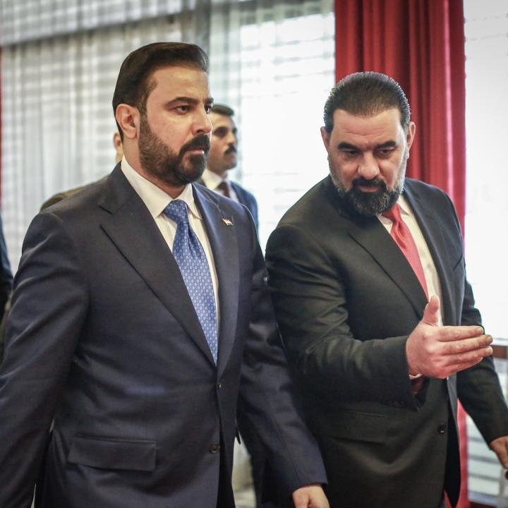 Tempering U.S. Expectations About Iraq’s New Government Iraqi Prime Minister Ali al-Zaidi walking alongside a political colleague who is gesturing with his hand indoors, capturing the internal discussions and structural dynamics shaping Iraq's New Government.