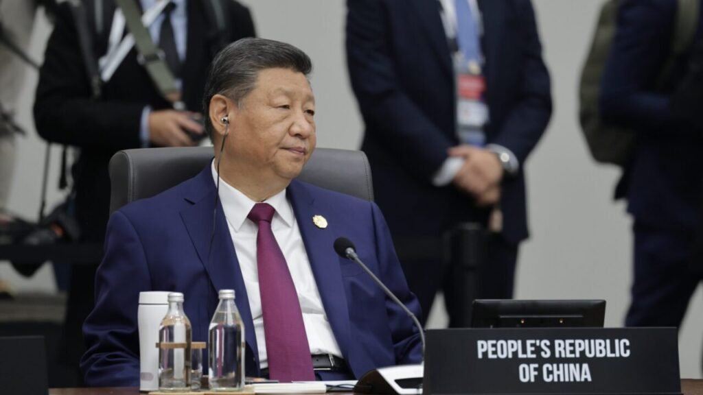 President Xi Jinping of the People’s Republic of China sits at a conference table with an earpiece during a summit, serving as a focal point to analyze how Beijing studies global conflicts like the Ukraine war.