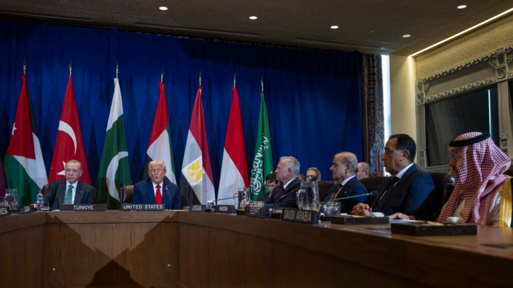 President Donald Trump and Turkish President Recep Tayyip Erdogan sit alongside world leaders at a large curved conference table during a multilateral meeting at the United Nations, visually framing shift dynamics toward a multilateral Nixon Doctrine.