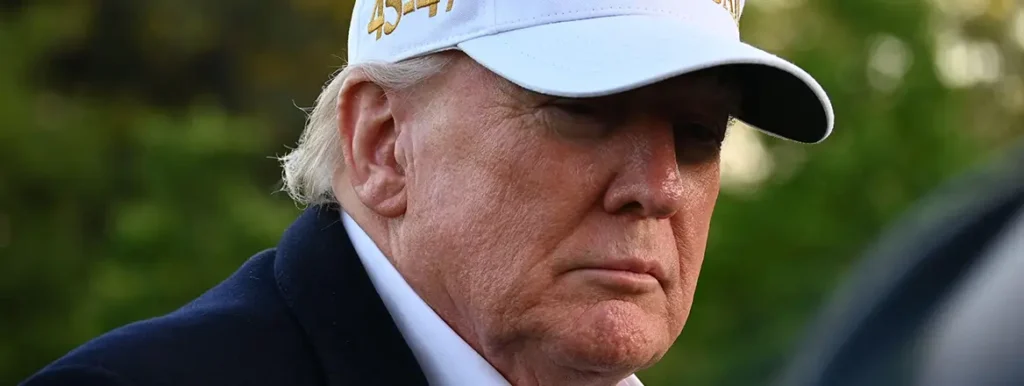 No-Rules Based Order: The World As It Really Is A tight, close-up profile view of Donald Trump looking downward with a serious expression while wearing a white baseball cap, emphasizing a stark visual atmosphere that mirrors the realpolitik of a No-Rules Based Order.