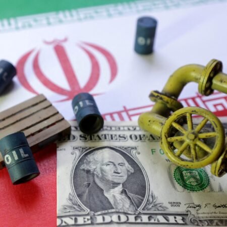 A close-up conceptual still life featuring a US one-dollar bill and a miniature yellow pipeline valve laid over the Iranian flag, surrounded by tiny mock oil barrels, symbolizing the financial and regulatory debates over a Treasury License.
