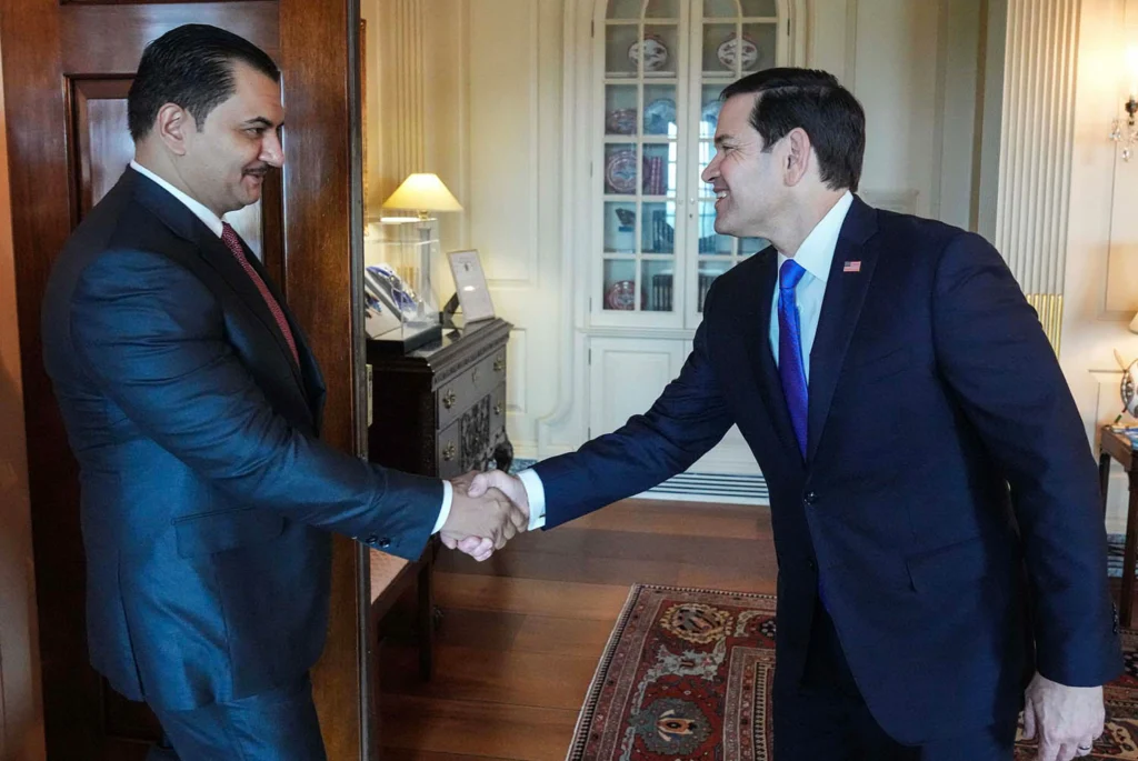 Libya doesn’t need another elite bargain U.S. Secretary of State Marco Rubio smiles while shaking hands with Libyan National Army Deputy Commander Saddam Haftar inside a formal office setting, representing the high-level diplomatic meetings connected to an elite bargain.