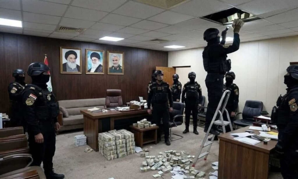 Armed Iraqi counter-terrorism forces in black tactical uniforms raid an office, with one officer on a stepladder pulling hidden cash bundles from the ceiling grid while massive stacks of money pile up on the floor, illustrating the context around the militia weapons handover.