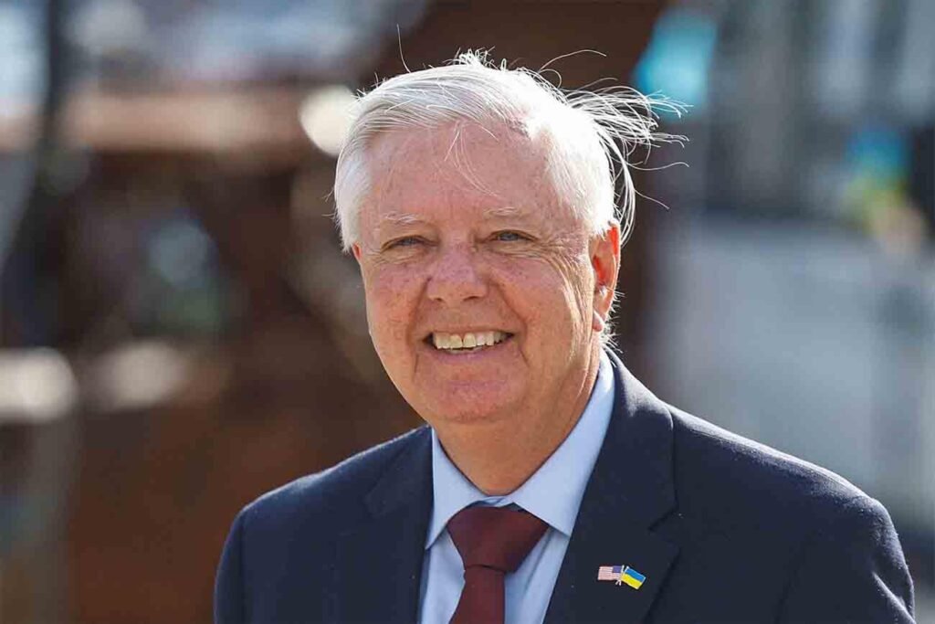 The Graham doctrine: How unconditional support for Israel reshaped America’s image in the Muslim World A close-up portrait of US Senator Lindsey Graham smiling while wearing a suit with a US-Ukraine lapel pin, representing foreign policy perspectives associated with the Graham doctrine.