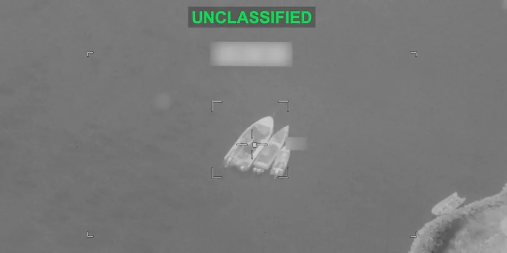 A monochrome aerial surveillance image showing targeting crosshairs centered on small watercraft positioned together in open water with an UNCLASSIFIED label at the top, illustrating maritime tensions capable of blowing up MOU.