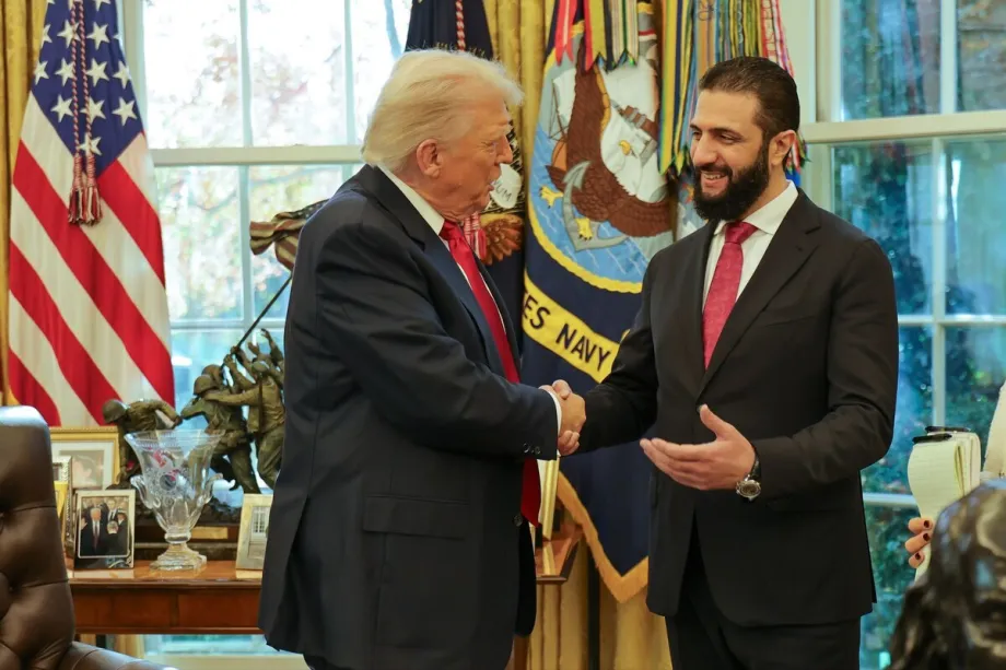 How Ankara rewired Syria’s future Donald Trump shaking hands with Syrian leader Ahmed al‑Sharaa inside the Oval Office with the American flag and US Navy flag in the background, framing regional discussions on Syria's future.