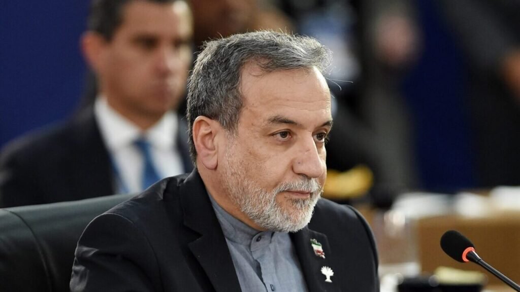 Iranian Foreign Minister Abbas Araghchi speaking at a microphone during a diplomatic conference, addressing prospects for US-Iran nuclear diplomacy.