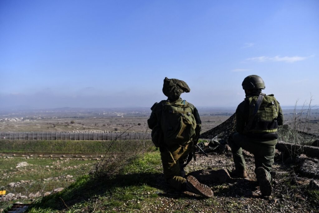 How to contain tensions between Israel and Turkey in Syria Two Israeli soldiers in tactical gear kneeling and observing the terrain in the Israeli-occupied Golan Heights near the border with Syria, highlighting the strategic environment impacting relations between Israel and Turkey.