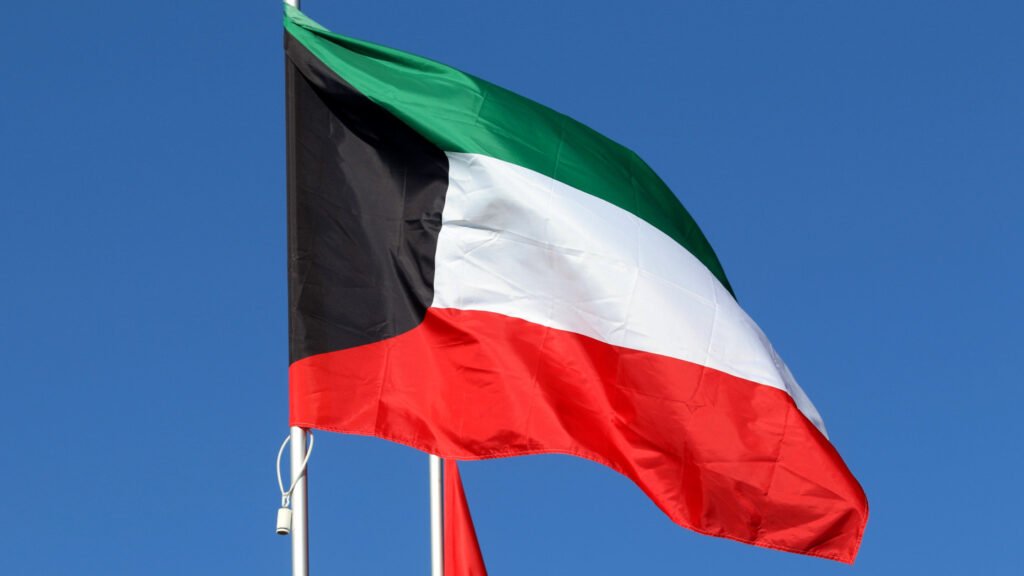 National flag of Kuwait waving against a clear blue sky, symbolizing the country's strategic defense realignment amid a broader Gulf Security Shift toward Pakistan.