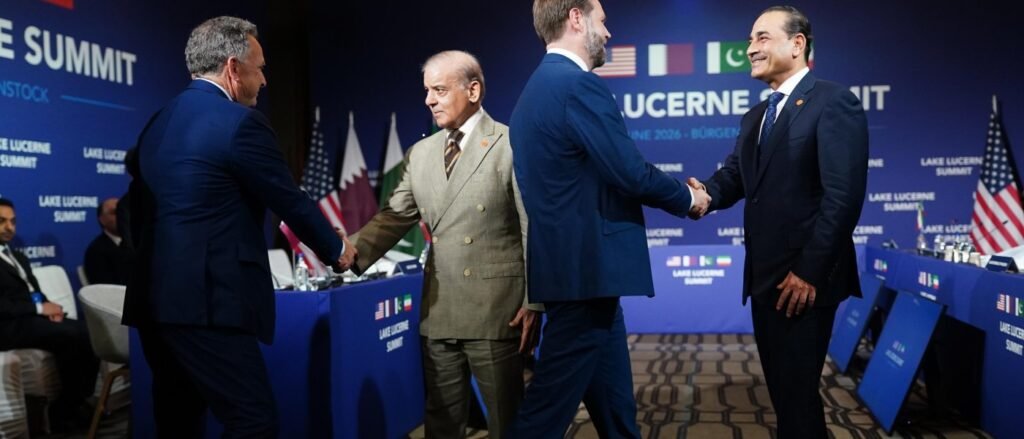 Lebanon in the Shadow of the U.S.-Iran MOU: Risks and Opportunities Officials shake hands during a high-level diplomatic gathering at the Lake Lucerne Summit, surrounded by international flags and branding, illustrating the broad geopolitical talks surrounding the U.S.-Iran MOU.