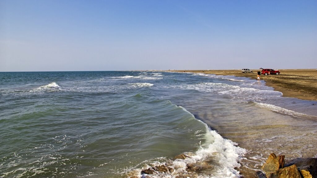 A wide view of waves breaking along the shoreline near Hudaydah, Yemen, highlighting geographic security near key global maritime chokepoints.