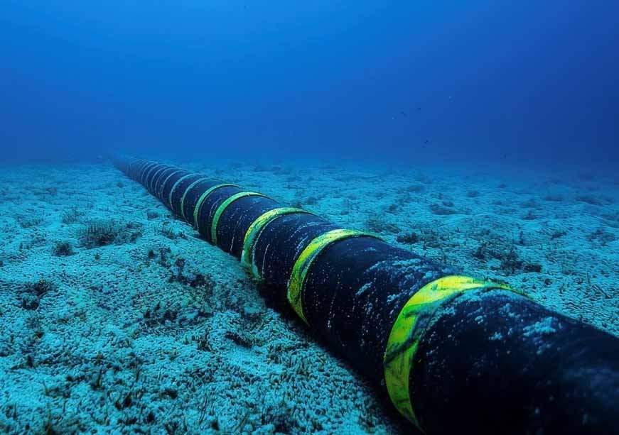 The Dark Ocean Challenge: Undersea Networks and the Future of Naval Warfare An undersea communications cable running across the ocean floor in deep blue water, representing critical seabed infrastructure relevant to modern naval warfare.