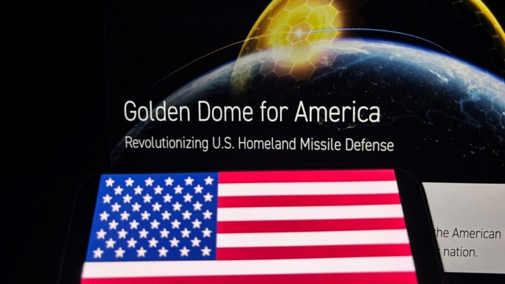 القبة الذهبية تحمي الوطن الأمريكي من تهديدات الصواريخ A digital presentation graphic showing the text "Golden Dome for America" and "Revolutionizing U.S. Homeland Missile Defense" over Earth, with a glowing golden honeycomb shield dome and a US flag in the foreground, visually illustrating the advanced technology of the Golden Dome system designed to shield the US homeland from missile threats.