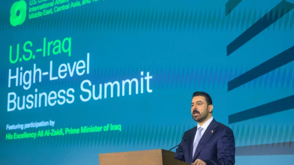 Iraq Foreign Policy Shifts to Balance US and Iran Iraqi Prime Minister Ali Al-Zaidi addressing the U.S.-Iraq High-Level Business Summit at a podium, demonstrating how diplomatic and economic engagement drives Iraq foreign policy to balance relations between the US and Iran.