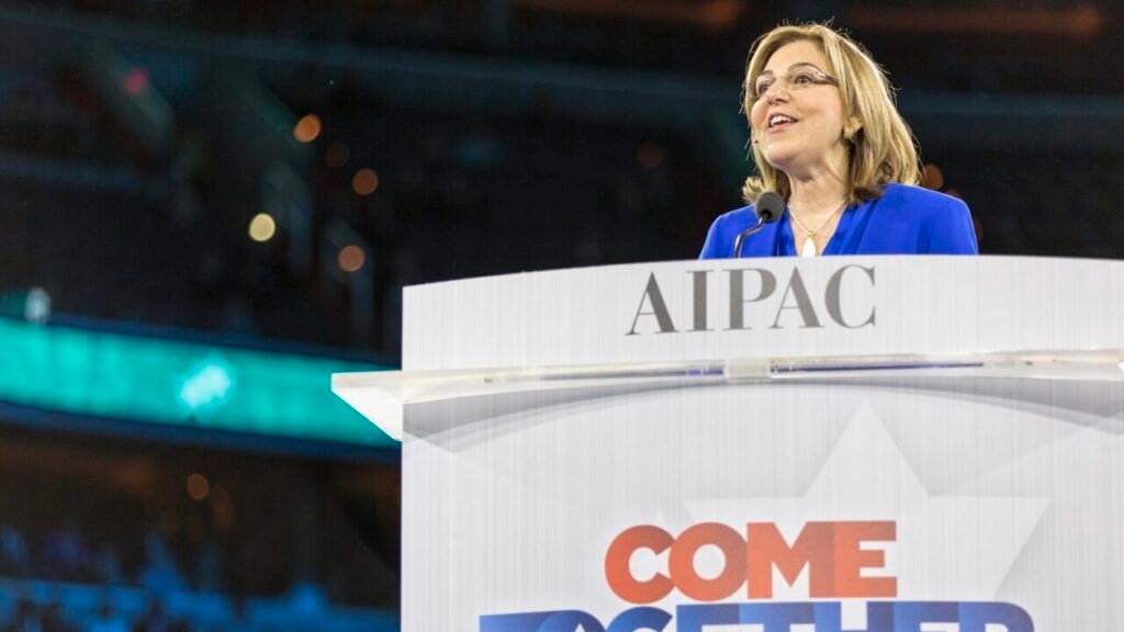 AIPAC Influence Fades in Democratic Primaries A photograph of then-AIPAC President Lillian Pinkus smiling and speaking at a podium bearing the AIPAC logo and a "Come Together" banner during the 2016 policy conference, juxtaposing this historical peak of organizational power against the article's argument that AIPAC Influence has since faded significantly in the Democratic primaries.