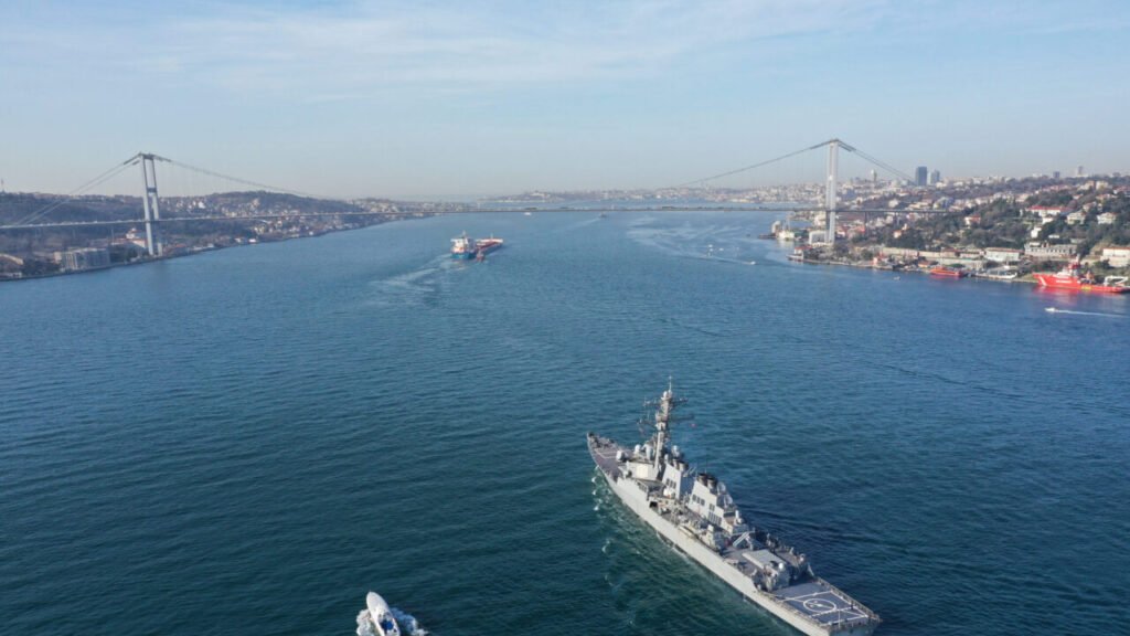 Aerial view of a US Navy vessel transiting the Bosphorus Strait, reflecting shifts under the Trump Maritime Doctrine.