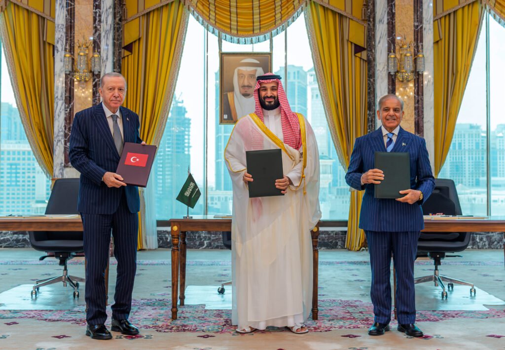 Iraqi Sovereignty Rejects the New Trilateral Axis Turkish President Erdogan, Saudi Crown Prince Mohammed bin Salman, and Pakistani Prime Minister Sharif hold signed agreement folders, forming a trilateral axis that impacts Iraqi Sovereignty.
