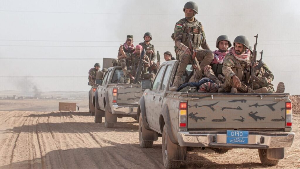 البشمركة الموحدة قد تحرم إيران من قاعدة حيوية في العراق Armed Kurdish soldiers in a pickup truck convoy representing a Unified Peshmerga.