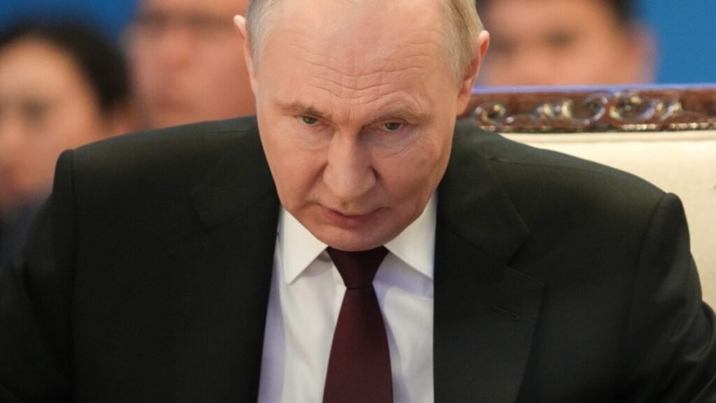 عقبنشینی روسیه از سوریه، ضرورت تسلیح اوکراین را تقویت میکند A close-up photograph of Russian President Vladimir Putin looking downward with a somber, contemplative expression against a blurred diplomatic background, visually symbolizing the geopolitical setbacks and strategic contraction that define the Russian Retreat from Syria, which in turn fuels the argument to arm Ukraine.
