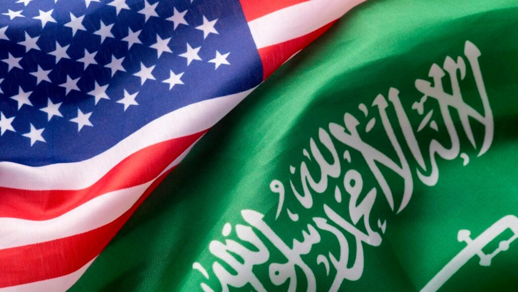 The American and Saudi Arabian flags draped side-by-side in a close-up, symbolizing the diplomatic stakes as US nuclear exports hinge on Saudi enrichment rules.