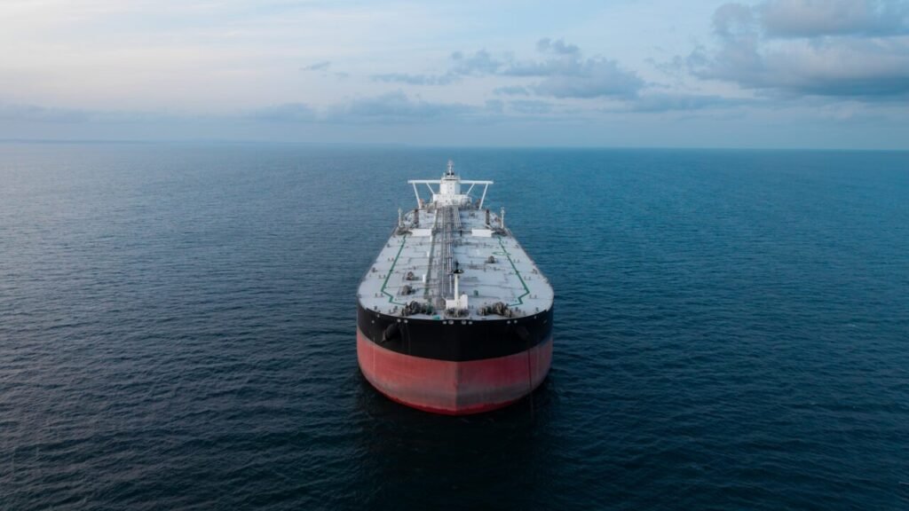 Aerial view of a large crude oil product tanker navigating through the Strait of Hormuz, highlighting maritime energy transit vulnerabilities associated with potential Iranian Escalation.