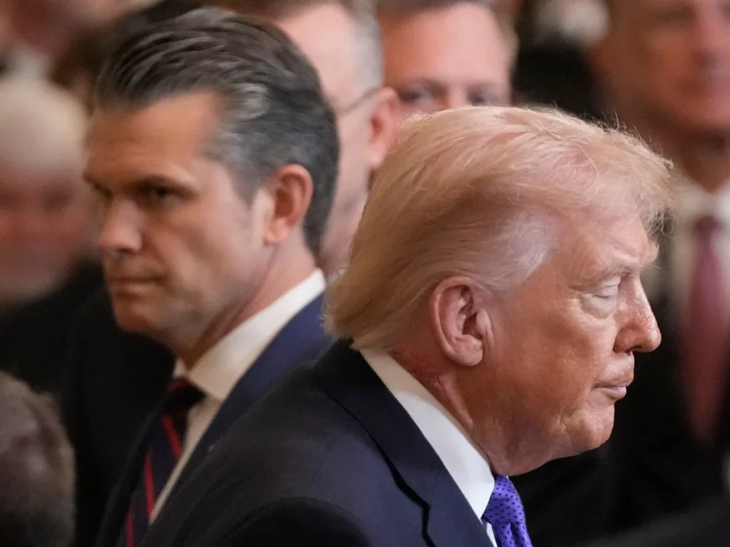 US President Donald Trump and Defense Secretary Pete Hegseth appearing in profile during an official gathering, symbolizing policy decisions amid the ongoing Iran War Quagmire.