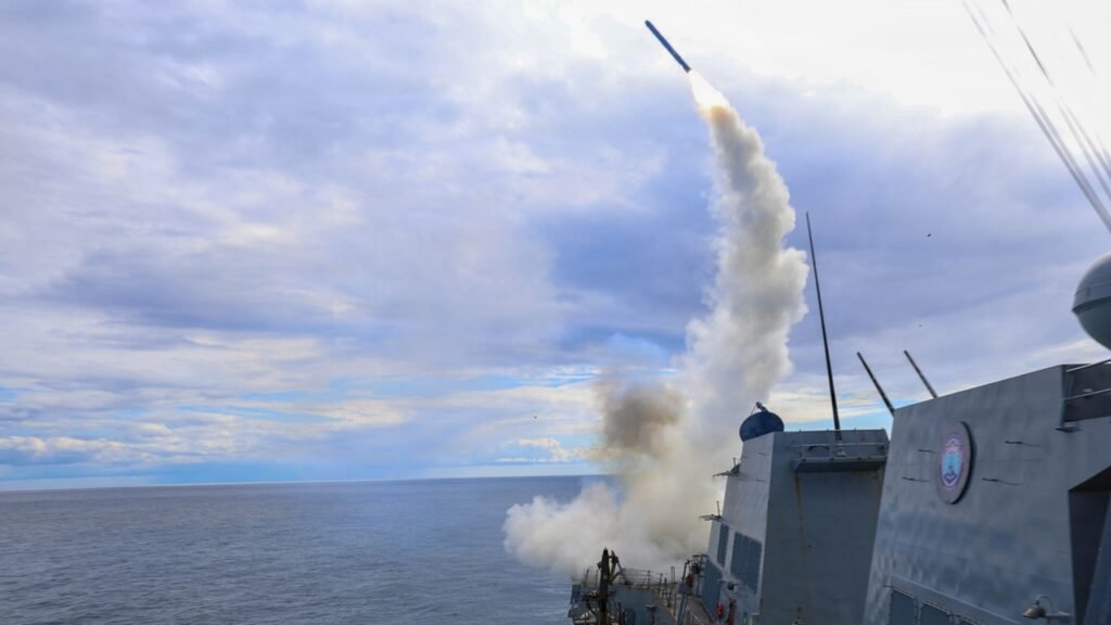 USS Thomas Hudner launching a Tomahawk missile at sea, illustrating the Pentagon's use of algorithmic targeting in AI Warfare Against Iran.