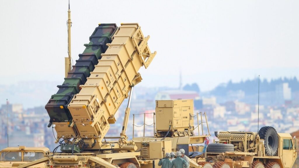 A US Patriot missile defense launcher system deployed on a heavy military vehicle, illustrating how US Air Defense capabilities serve as the primary security guarantee for the Gulf region.