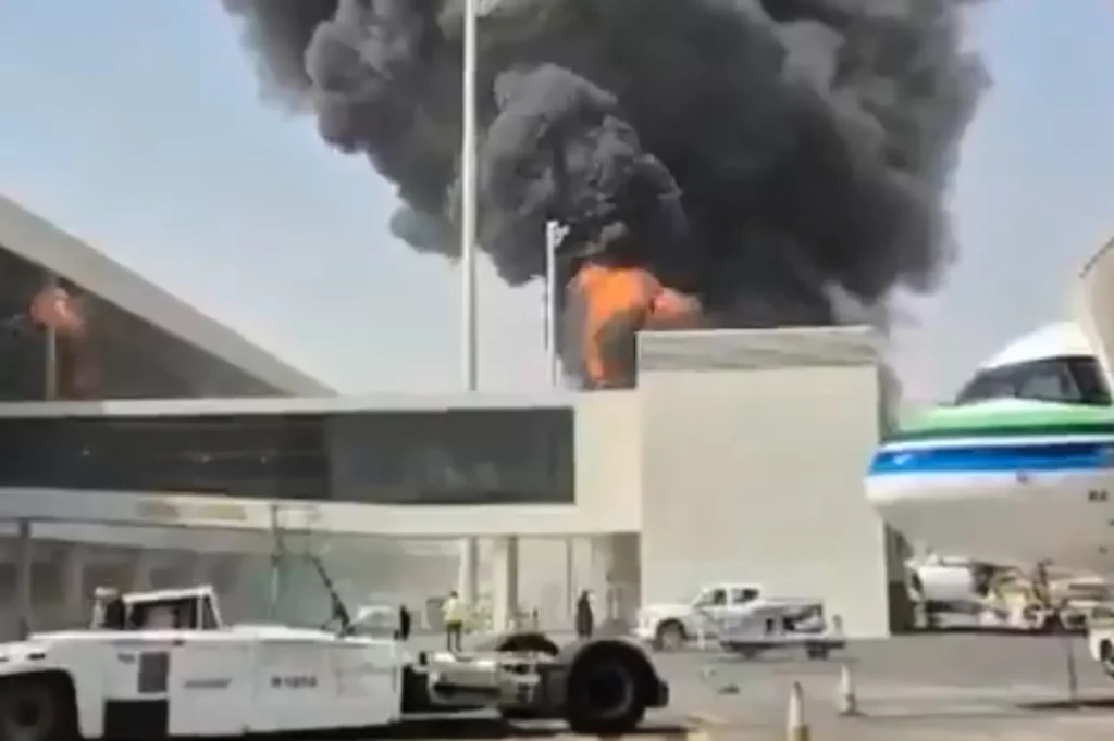 Black smoke and flames rise from a building during the Riyadh Airport Attack, illustrating how spoilers can veto peace.